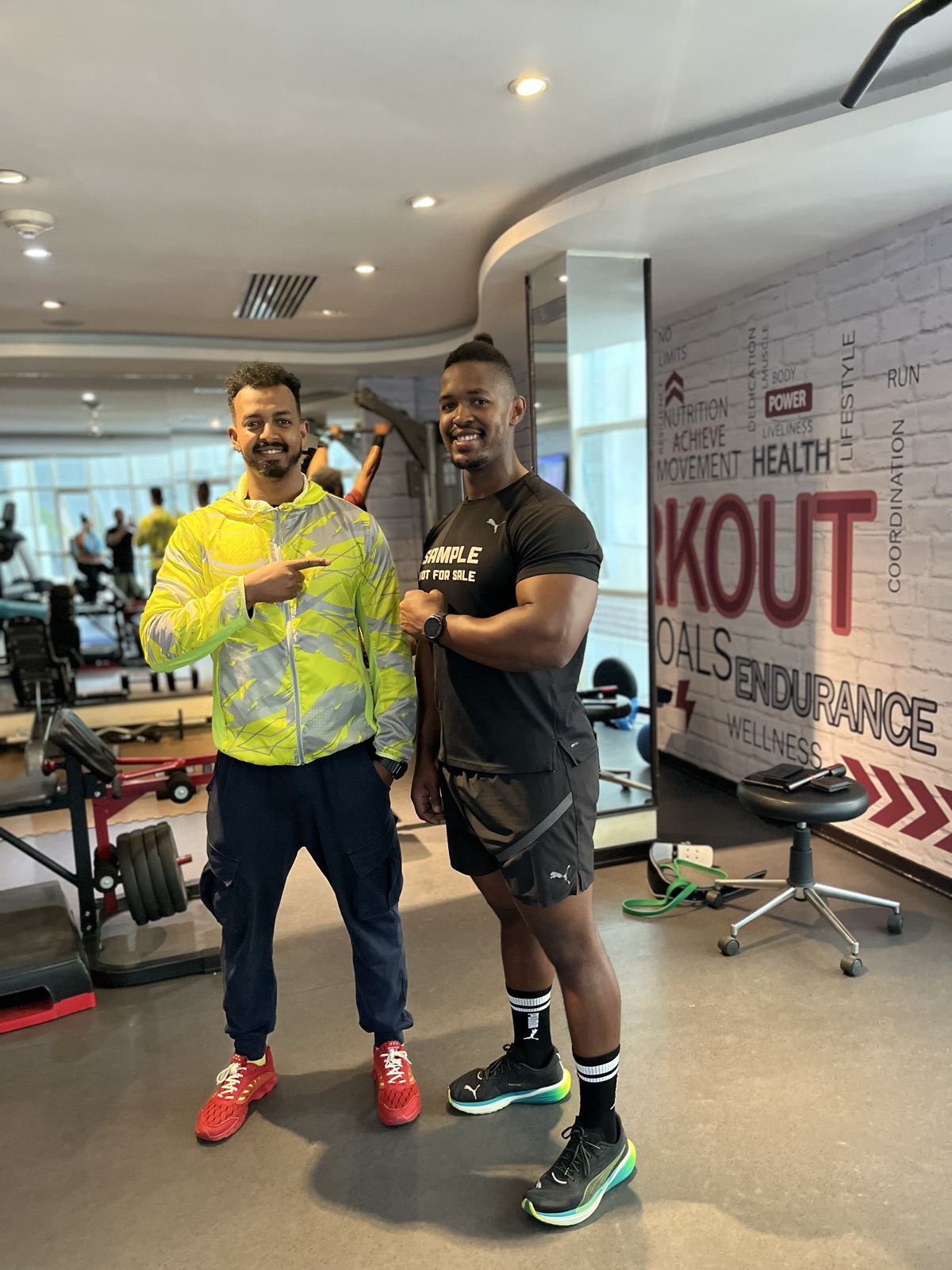 Coach Miki with a client at the gym