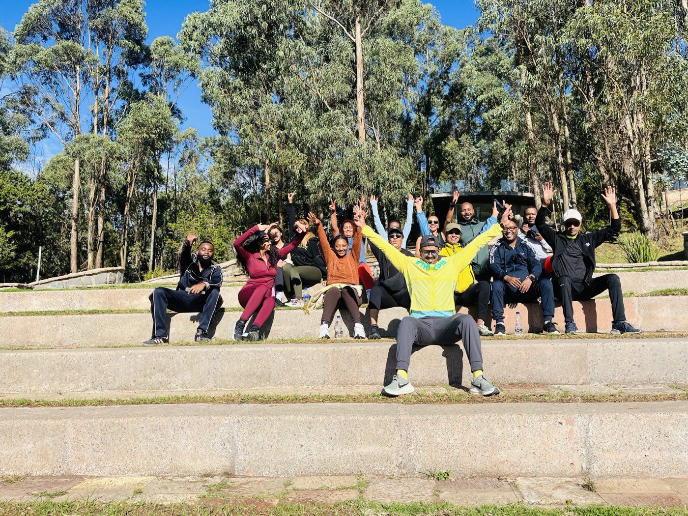 Community training group cheering on outdoor steps